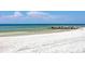 White sand beach and calm ocean water at 2100 Benjamin Franklin Dr # 108, Sarasota, FL 34236