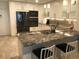 Modern kitchen with stainless steel appliances and granite island at 2100 Benjamin Franklin Dr # 108, Sarasota, FL 34236