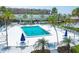 Community pool with lounge chairs and umbrellas at 2100 Benjamin Franklin Dr # 108, Sarasota, FL 34236