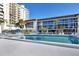 Community pool with surrounding lounge chairs at 2100 Benjamin Franklin Dr # 108, Sarasota, FL 34236