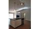 Modern kitchen with island and breakfast bar at 2537 Tishman Ave, North Port, FL 34286