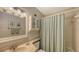 Clean bathroom with a shower/tub combo, vanity, and linen storage at 2621 Golf Course Dr # 401, Sarasota, FL 34234