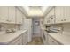 White kitchen with appliances and ample counter space at 2621 Golf Course Dr # 401, Sarasota, FL 34234