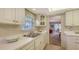 Kitchen features white cabinets and double sink at 2621 Golf Course Dr # 401, Sarasota, FL 34234