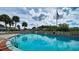 Refreshing community pool with ladder access and surrounding patio at 2621 Golf Course Dr # 401, Sarasota, FL 34234