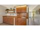 Detailed view of a built-in wet bar with wood cabinets and a sink at 2621 Golf Course Dr # 401, Sarasota, FL 34234