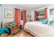 Bright bedroom with a queen bed and wicker chair at 2885 Arrowhead Rd, Venice, FL 34293