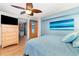 Bright bedroom with light wood dresser and a calming blue bedding set at 2885 Arrowhead Rd, Venice, FL 34293