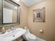 Small powder room with white sink and toilet at 3060 Grand Bay Blvd # 113, Longboat Key, FL 34228