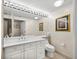 Bathroom with vanity, toilet and large mirror at 3060 Grand Bay Blvd # 113, Longboat Key, FL 34228