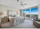 Main bedroom with water view and access to balcony at 3060 Grand Bay Blvd # 113, Longboat Key, FL 34228