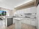 Modern kitchen with white cabinets and island at 3060 Grand Bay Blvd # 113, Longboat Key, FL 34228