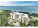 Aerial view of building showcasing waterfront location and amenities at 3080 Grand Bay Blvd # 544, Longboat Key, FL 34228