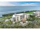 An aerial shot showcasing a condo building's waterfront location and architecture at 3080 Grand Bay Blvd # 544, Longboat Key, FL 34228