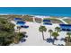 Beach with picnic tables and palm trees at 3080 Grand Bay Blvd # 544, Longboat Key, FL 34228