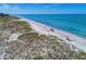 Aerial view of beach with people enjoying the sun at 3080 Grand Bay Blvd # 544, Longboat Key, FL 34228