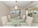 Elegant dining area with glass table and ocean views at 3080 Grand Bay Blvd # 544, Longboat Key, FL 34228