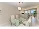 Bright dining room with glass top table and striped chairs at 3080 Grand Bay Blvd # 544, Longboat Key, FL 34228