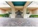 Elegant condo building entrance with columns and a teal covered walkway at 3080 Grand Bay Blvd # 544, Longboat Key, FL 34228