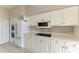 Well-equipped kitchen with white cabinetry and ample counter space at 3080 Grand Bay Blvd # 544, Longboat Key, FL 34228