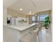 Modern kitchen with white cabinets and breakfast bar at 3080 Grand Bay Blvd # 544, Longboat Key, FL 34228