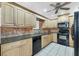 Modern kitchen with light wood cabinets, granite counters and black appliances at 3231 Yorktown St, Sarasota, FL 34231