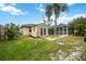 Tan colored storage shed in backyard with grassy area at 3506 Culpepper Ter, North Port, FL 34286