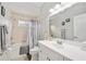 Clean bathroom, bathtub, shower, and white vanity at 3506 Culpepper Ter, North Port, FL 34286