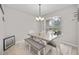 Bright dining room features a table with bench seating and chandelier at 3506 Culpepper Ter, North Port, FL 34286