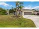 Single-story house with palm trees, landscaped lawn, and a large driveway at 3506 Culpepper Ter, North Port, FL 34286