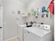 Laundry room with washer, dryer, and shelving at 3506 Culpepper Ter, North Port, FL 34286