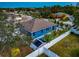 Blue house with a pool and backyard shed, aerial view at 363 64Th Avenue E Cir, Bradenton, FL 34203