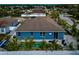 Blue house with a pool and patio, viewed from above at 363 64Th Avenue E Cir, Bradenton, FL 34203