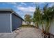 Gravel backyard with a white fence and a small tree at 363 64Th Avenue E Cir, Bradenton, FL 34203