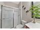 Bathroom with a shower and toilet. Decorated with tropical plants at 363 64Th Avenue E Cir, Bradenton, FL 34203