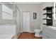 Clean bathroom with a shower, toilet, and built-in shelving at 363 64Th Avenue E Cir, Bradenton, FL 34203