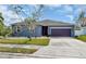 Single-story home with gray exterior, purple garage door, and landscaping at 363 64Th Avenue E Cir, Bradenton, FL 34203