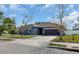 Single-story home, gray exterior, purple garage door, landscaping at 363 64Th Avenue E Cir, Bradenton, FL 34203