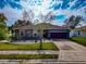 Single-story house with gray exterior and purple garage door at 363 64Th Avenue E Cir, Bradenton, FL 34203