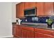 Kitchen features dark wood cabinets, a modern cooktop and dark countertops at 363 64Th Avenue E Cir, Bradenton, FL 34203