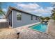 Modern pool with gray patio and tropical landscaping at 363 64Th Avenue E Cir, Bradenton, FL 34203