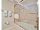 Substantial bathroom with a shower/tub combo and tiled walls at 3843 E 59 Avenue Cir, Ellenton, FL 34222