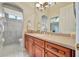 Bathroom with wood cabinets, a vessel sink, and a walk-in shower at 3843 E 59 Avenue Cir, Ellenton, FL 34222