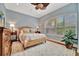 Bedroom with wicker bed frame, patterned bedding, and wood floors at 3843 E 59 Avenue Cir, Ellenton, FL 34222