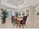 Bright dining room with chandelier, window seating, and hardwood floors at 3843 E 59 Avenue Cir, Ellenton, FL 34222