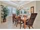 Formal dining room with a chandelier and hardwood floors, seating for six at 3843 E 59 Avenue Cir, Ellenton, FL 34222