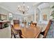 Bright dining room with a chandelier and seating for six at 3843 E 59 Avenue Cir, Ellenton, FL 34222