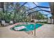 Relaxing screened pool and spa with surrounding tropical plants at 3843 E 59 Avenue Cir, Ellenton, FL 34222