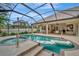 Screened pool and spa with plenty of seating and a floating mat at 3843 E 59 Avenue Cir, Ellenton, FL 34222