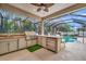 Outdoor kitchen, pool, and screened patio at 3843 E 59 Avenue Cir, Ellenton, FL 34222